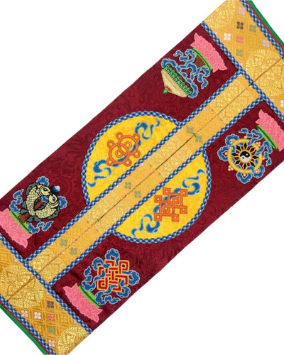 The Dragon, the Eight Auspicious Symbols, the King's Bracelet, and the Queen's Chariot are intricately embroidered. The design is finished with fishbone stitching and decorated with a coin braid stitch on wine red and yellow dual tone silk. 