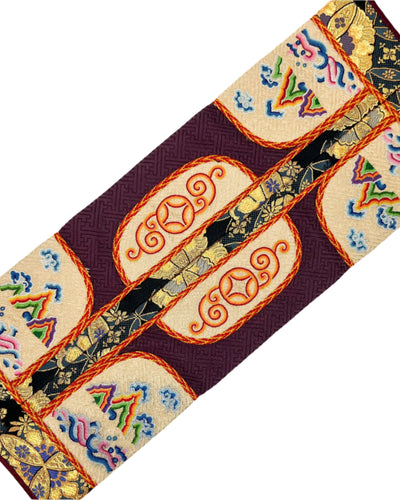 The 12 Zodiac Animals, Stallion Wrestling, Mountains, Clouds, and River are intricately embroidered. The design is finished with fishbone stitching and double-layered coin braid stitching for decoration on a burgundy and beige silk.