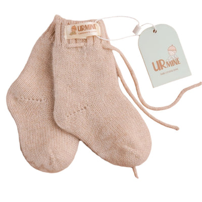 Soft beige baby cashmere socks featuring ankle cuffs, designed for ultimate comfort and warmth.