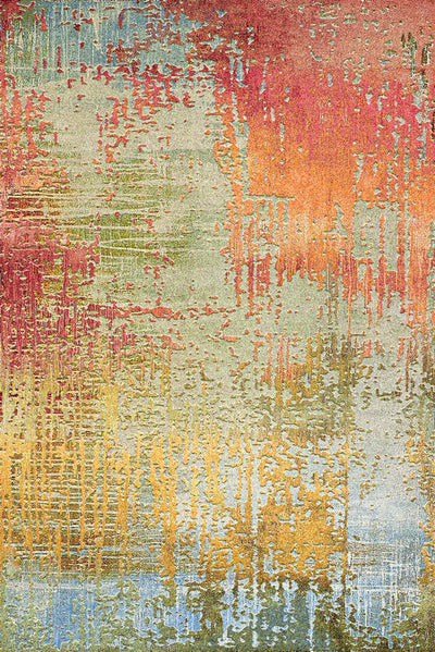 A carpet featuring an abstract design with vibrant colors in shades of red, orange, yellow, green, and blue, set against a textured background.